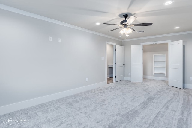 unfurnished bedroom featuring visible vents, crown molding, baseboards, light carpet, and recessed lighting