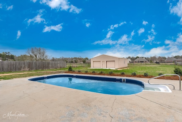 view of pool with a yard, an outbuilding, a fenced in pool, and fence