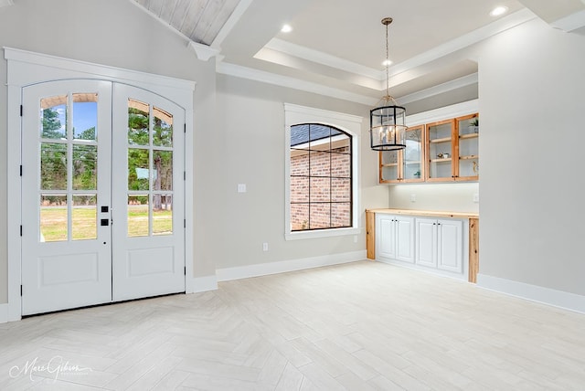 entryway featuring baseboards, a tray ceiling, ornamental molding, recessed lighting, and french doors