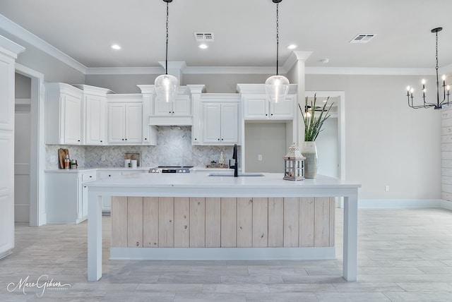 kitchen with a sink, visible vents, and decorative backsplash