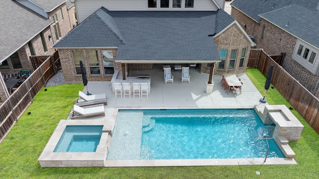 view of swimming pool with a patio, an in ground hot tub, a yard, a fenced backyard, and outdoor dry bar