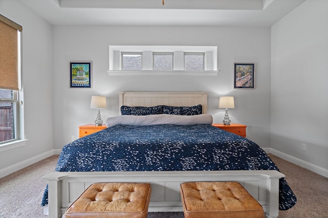 bedroom with multiple windows, baseboards, and carpet floors