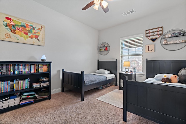 carpeted bedroom with visible vents and a ceiling fan