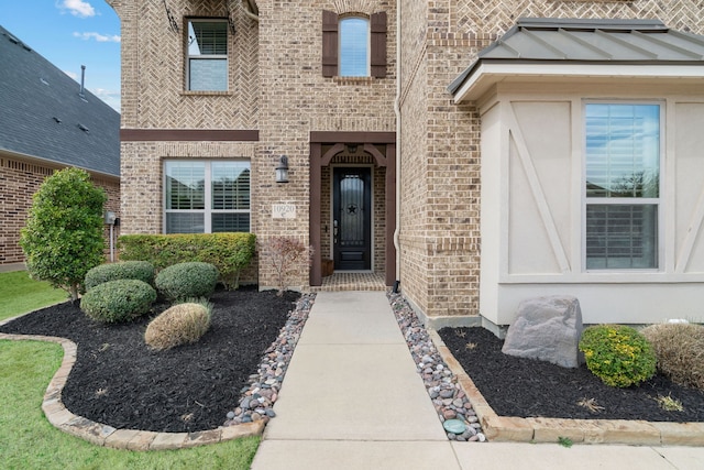 doorway to property featuring brick siding