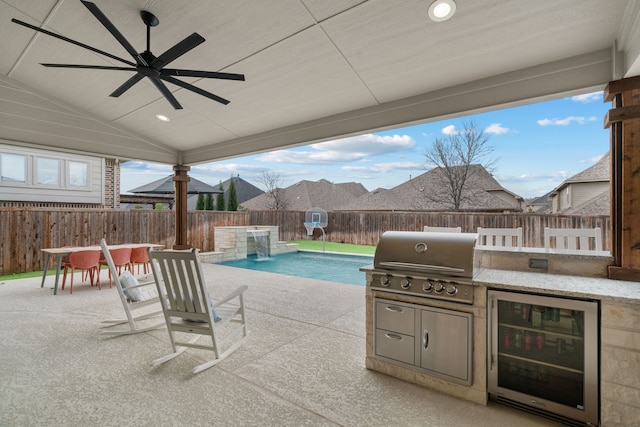 view of pool with outdoor dining area, a patio, area for grilling, and a fenced backyard