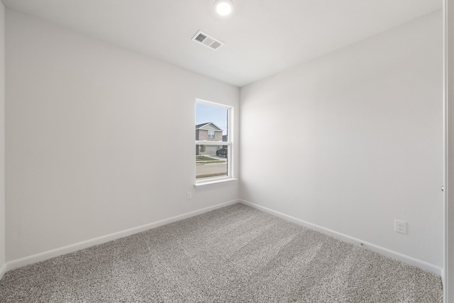 spare room featuring visible vents, baseboards, and carpet