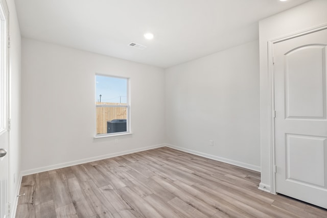 spare room with visible vents, recessed lighting, baseboards, and light wood-style floors