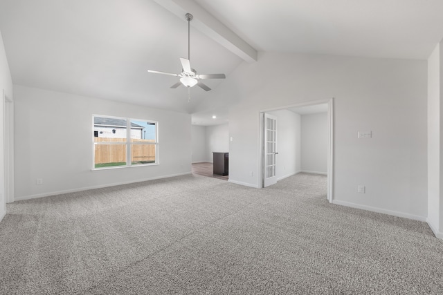 unfurnished living room with vaulted ceiling with beams, a ceiling fan, baseboards, and light carpet