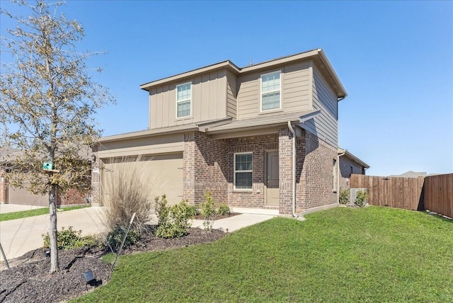 view of front of home with a front yard, fence, driveway, brick siding, and board and batten siding