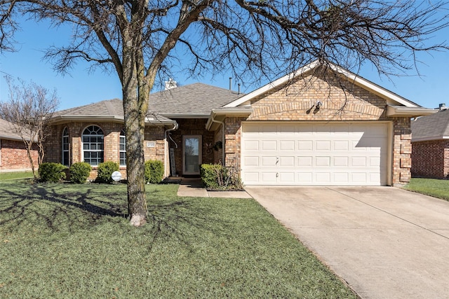 single story home featuring a garage, brick siding, and a front yard