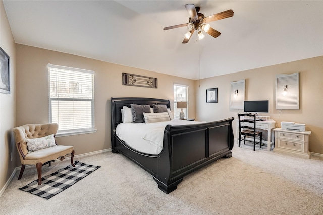 bedroom with light colored carpet, baseboards, lofted ceiling, and multiple windows