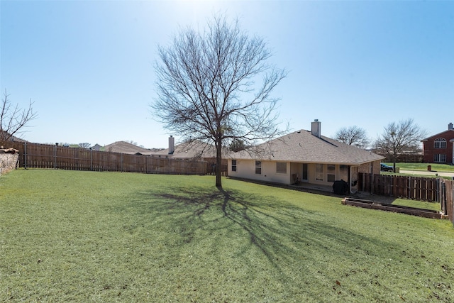 view of yard with a fenced backyard