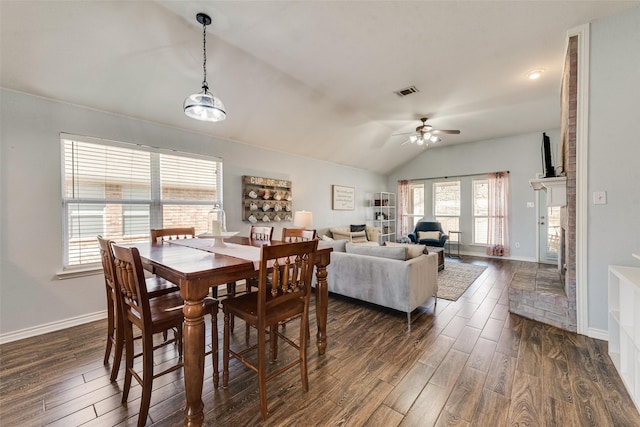 dining room featuring visible vents, baseboards, lofted ceiling, and dark wood-style flooring