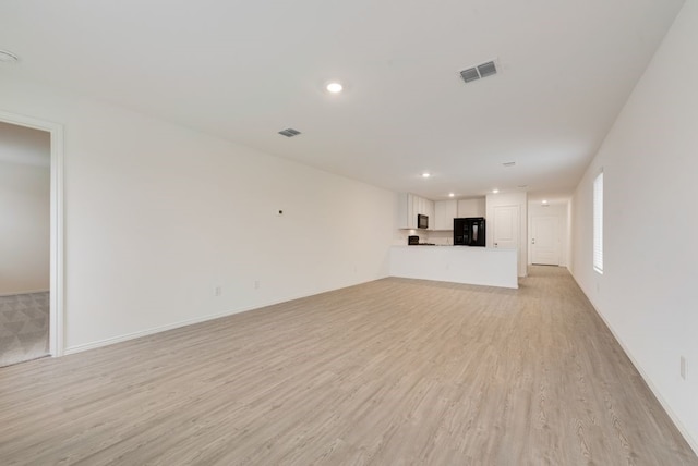 unfurnished living room with recessed lighting, visible vents, and light wood-style flooring