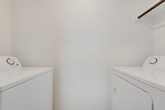 laundry room featuring separate washer and dryer and laundry area