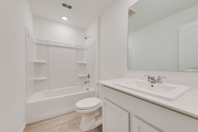 bathroom featuring tub / shower combination, visible vents, toilet, and wood finished floors