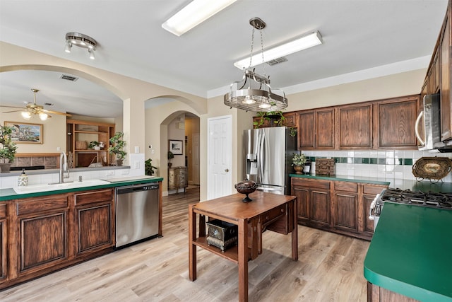 kitchen featuring a sink, visible vents, backsplash, and stainless steel appliances