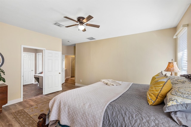 bedroom featuring visible vents, baseboards, wood finished floors, and a ceiling fan