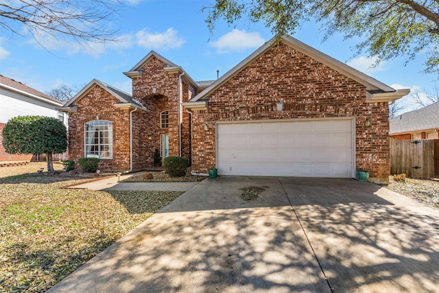 traditional-style house featuring brick siding, driveway, a garage, and fence