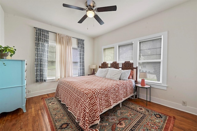 bedroom featuring a ceiling fan, wood finished floors, and baseboards