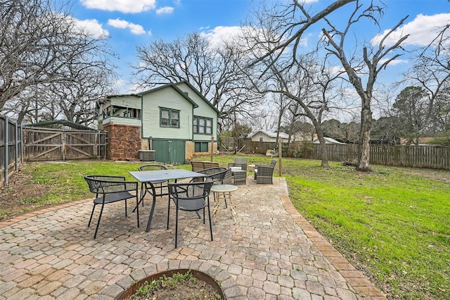 view of patio featuring a gate, a fenced backyard, and a fire pit