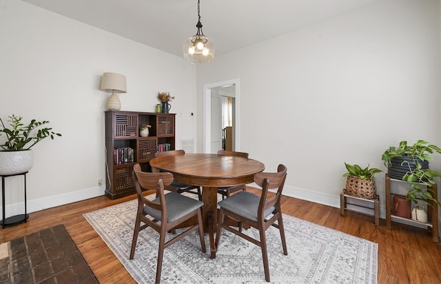 dining room with baseboards and wood finished floors