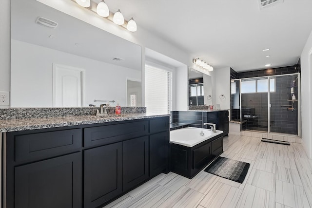 bathroom featuring vanity, a garden tub, visible vents, and a stall shower