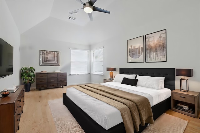 bedroom featuring light wood-type flooring, visible vents, a ceiling fan, and vaulted ceiling