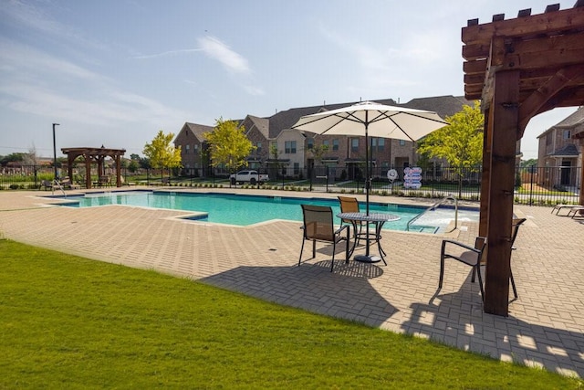 community pool featuring a patio, a yard, fence, and a pergola