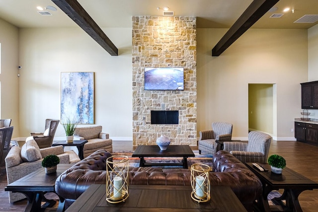 living area with beam ceiling, visible vents, a fireplace, and dark wood-style floors