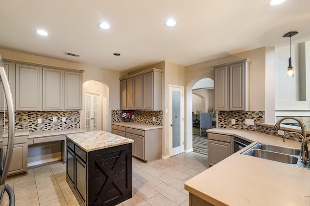 1513 Hidden Cove Ct, Allen, TX 75002 - kitchen with arched walkways, a sink, backsplash, gray cabinets, and recessed lighting