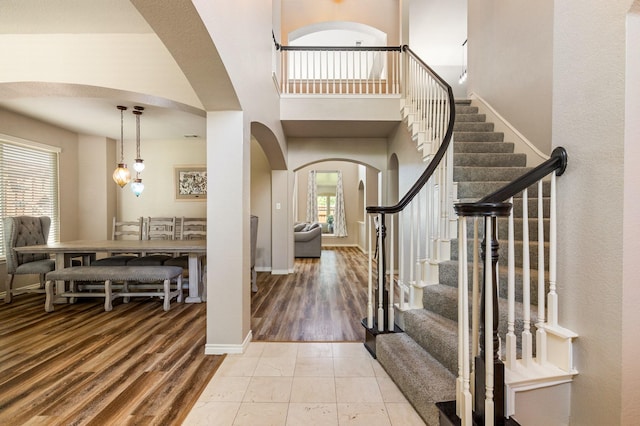 1513 Hidden Cove Ct, Allen, TX 75002 - foyer entrance featuring arched walkways, stairway, baseboards, and wood finished floors