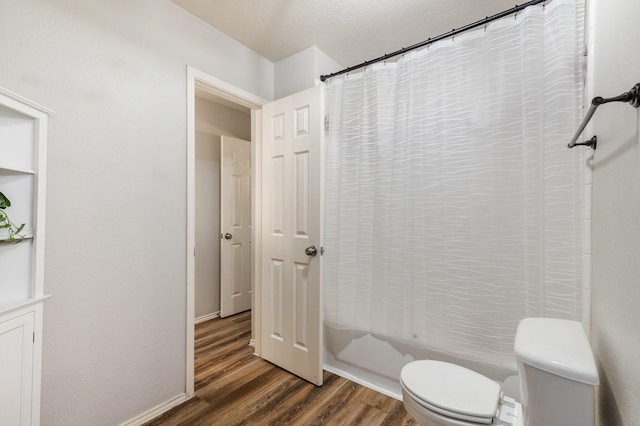 1513 Hidden Cove Ct, Allen, TX 75002 - full bathroom featuring toilet, wood finished floors, a textured ceiling, and shower / bath combination with curtain