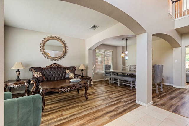 1513 Hidden Cove Ct, Allen, TX 75002 - living area with arched walkways, plenty of natural light, and wood finished floors