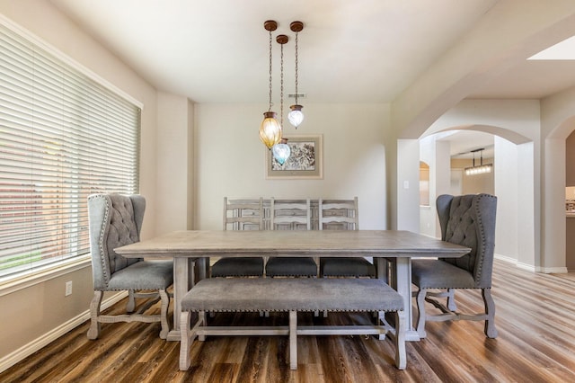 1513 Hidden Cove Ct, Allen, TX 75002 - dining area with arched walkways, wood finished floors, and baseboards