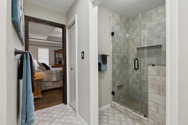 bathroom featuring ensuite bath, baseboards, a stall shower, and tile patterned floors