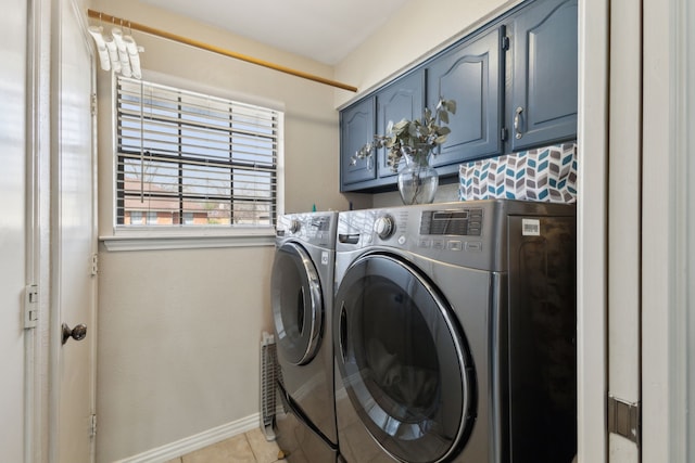 laundry area with light tile patterned flooring, cabinet space, independent washer and dryer, and baseboards