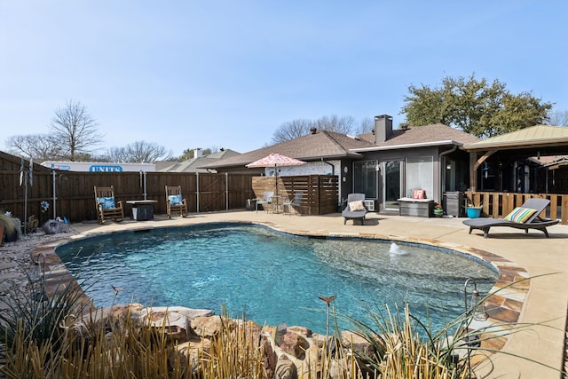 view of swimming pool featuring a fenced backyard, a fenced in pool, and a patio