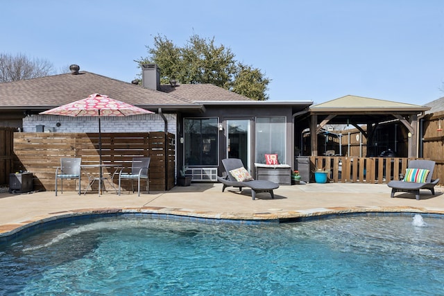 view of pool with a gazebo, a fenced in pool, a patio, and fence