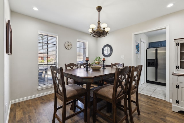 dining room with recessed lighting, baseboards, an inviting chandelier, and dark wood-style flooring