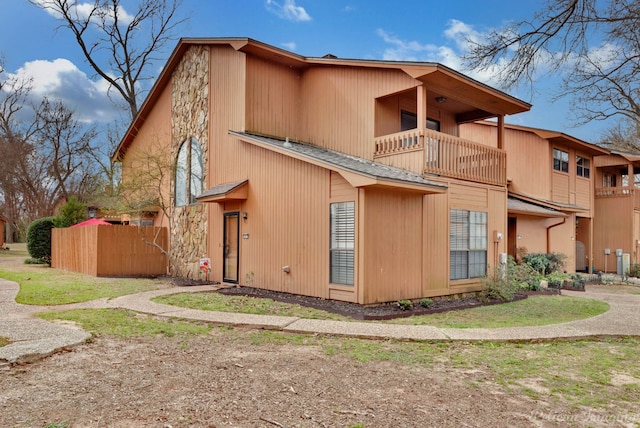 exterior space with a balcony and fence