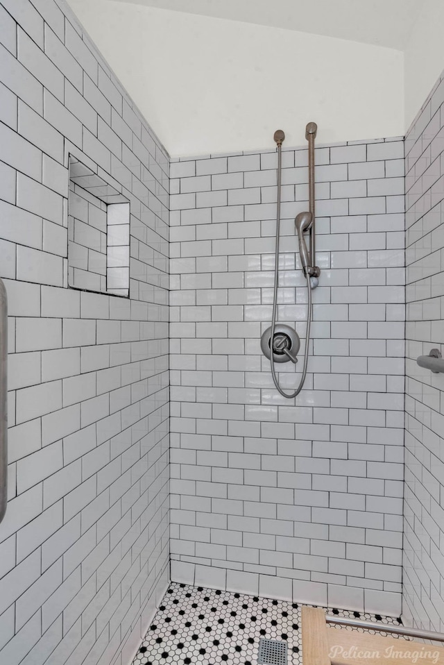 bathroom with tiled shower