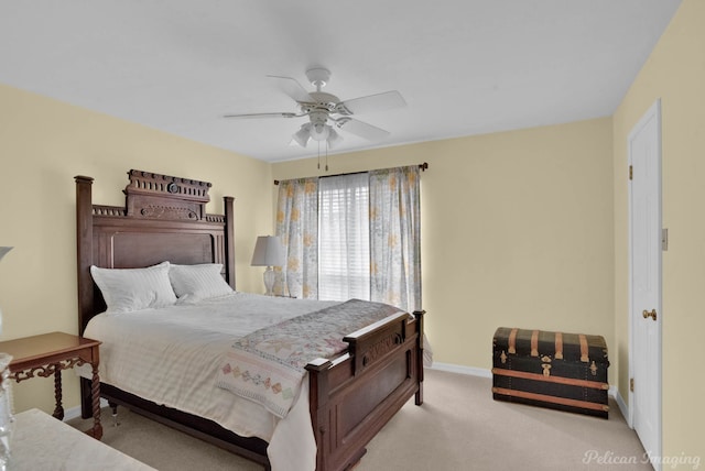 carpeted bedroom with a ceiling fan and baseboards