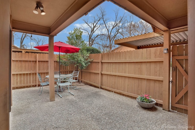 view of patio with outdoor dining space and fence