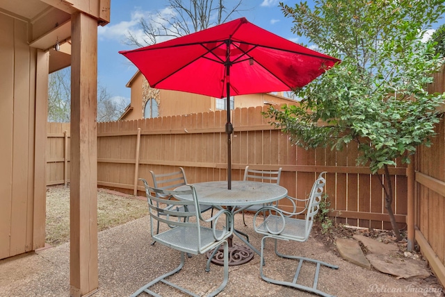 view of patio / terrace with outdoor dining space and fence