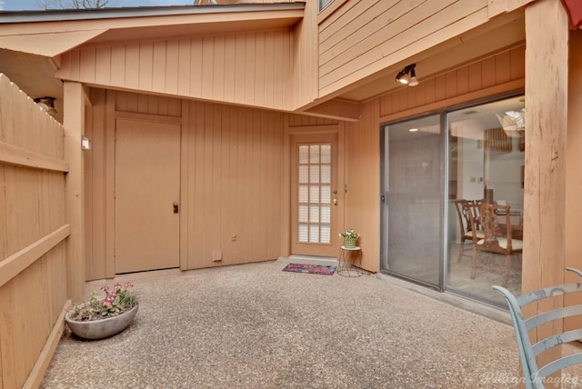 doorway to property featuring a patio area and fence