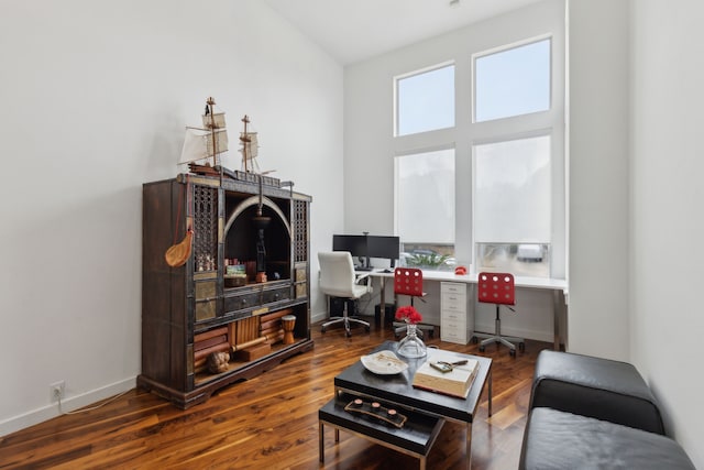 office space featuring baseboards and wood finished floors