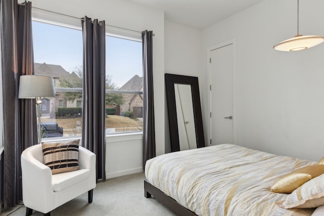 carpeted bedroom featuring baseboards