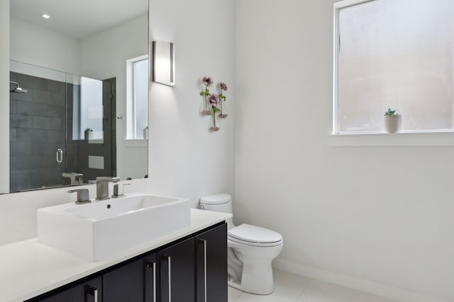 bathroom with vanity, baseboards, a stall shower, tile patterned flooring, and toilet