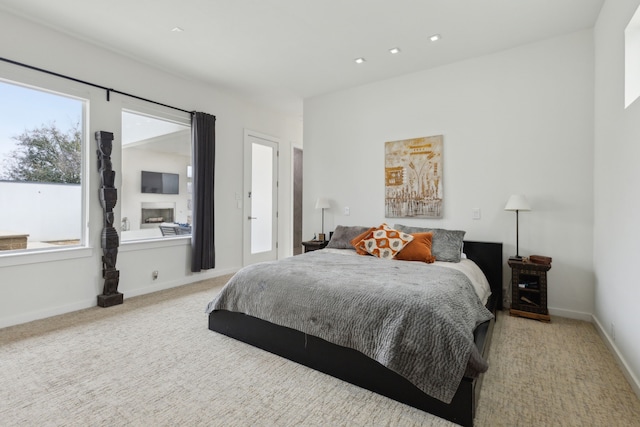 carpeted bedroom with a fireplace, recessed lighting, and baseboards